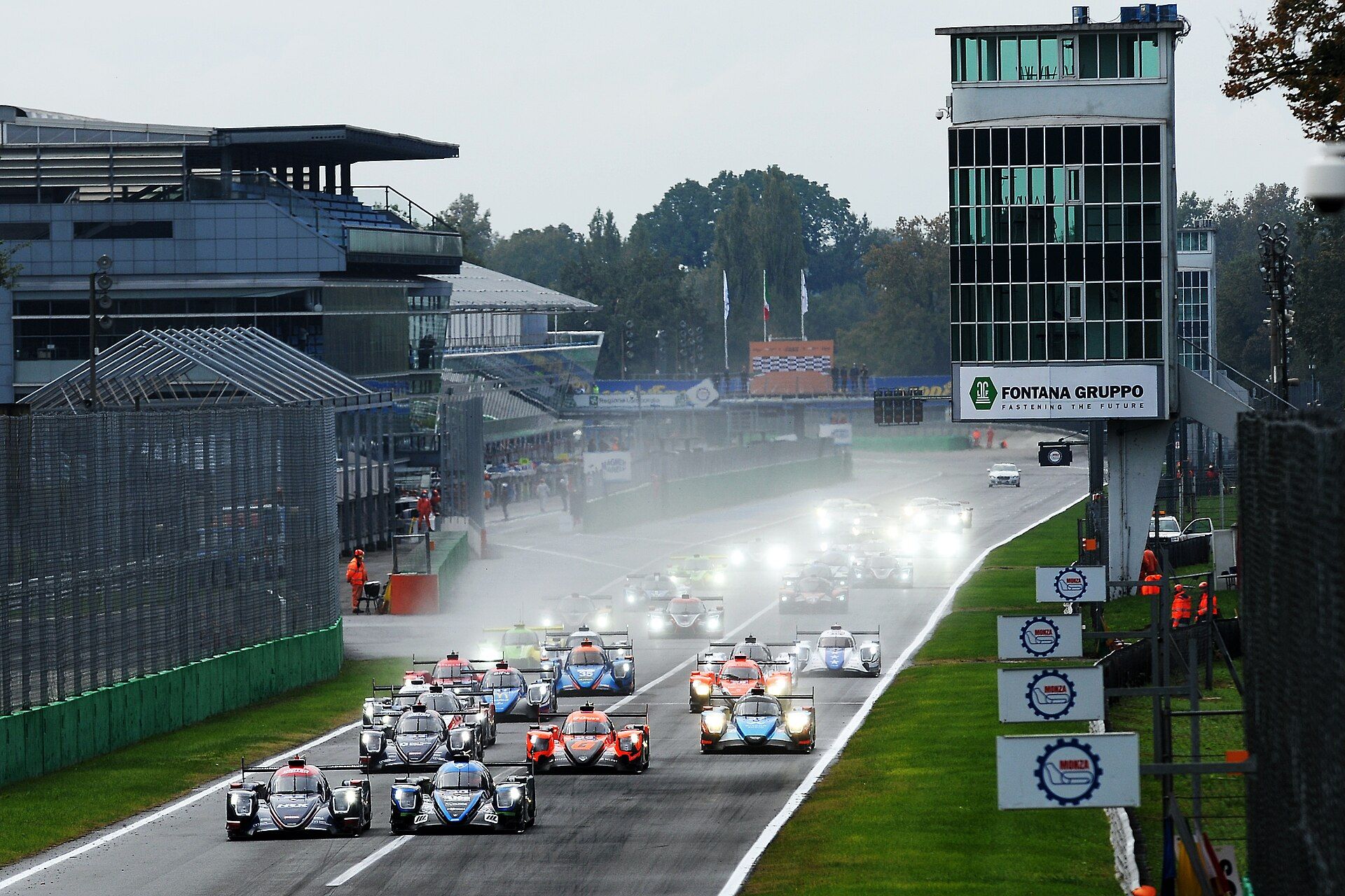 Prototypy na mokrej prostej startowej Autodromo Nazionale Monza, po prawej wieża toru